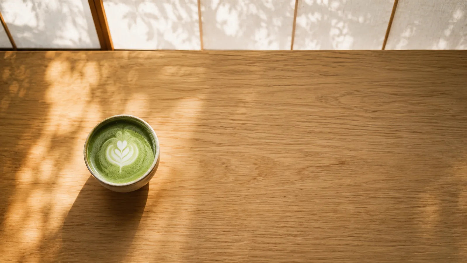 A bowl of matcha on a wooden table